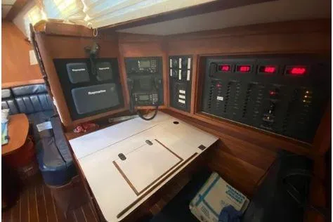 Slide: The Image of Navigation station inside 1997 Freedom 45 yacht with control panels and seating area. - 14