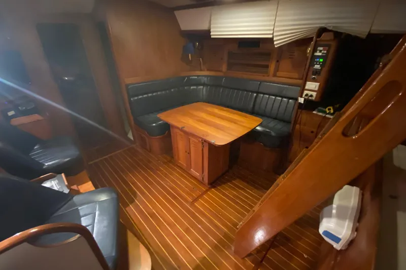 Slide: The Image of Cozy 1997 Freedom 45 yacht interior with wooden furnishings and leather seating. - 18