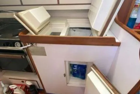 Slide: The Image of Interior view of a 1997 Freedom 45 yacht kitchen with open storage compartments. - 19