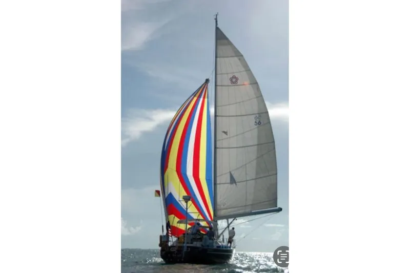 Slide: The Image of Colorful sailboat "Freedom 45" from 1997 sailing under a vibrant sky. - 2