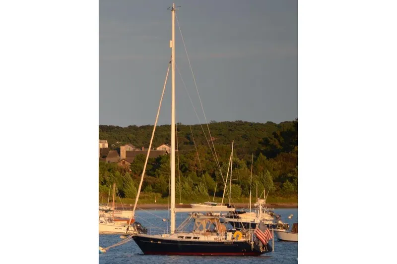 Slide: The Image of Sailboat Freedom 45 (1997) anchored in scenic coastal waters. - 3