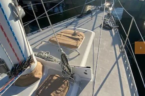 Slide: The Image of Sailboat deck of 1997 Freedom 45, featuring rigging and hatches in sunlight. - 6