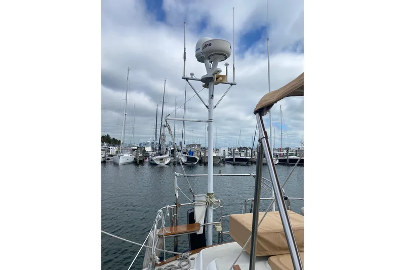 Slide: The Image of Sailboat docked at marina, Freedom 45 model, 1997, with radar equipment and clear sky. - 8