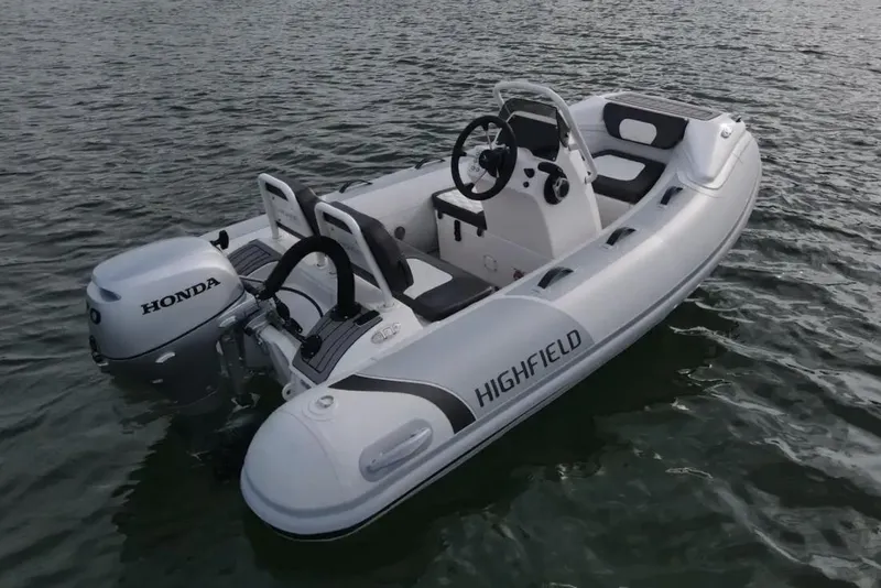 The Image of Manufacturer Provided Image: 2023 Highfield Sport 300 inflatable boat with Honda outboard motor on water. - 0