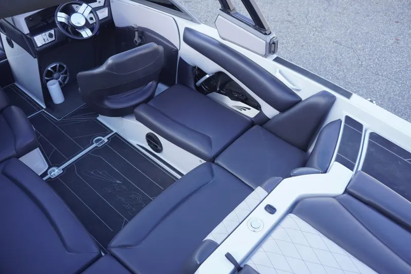 Slide: The Image of 2019 Tigé R20 boat interior with sleek black seating and modern dashboard design. - 16