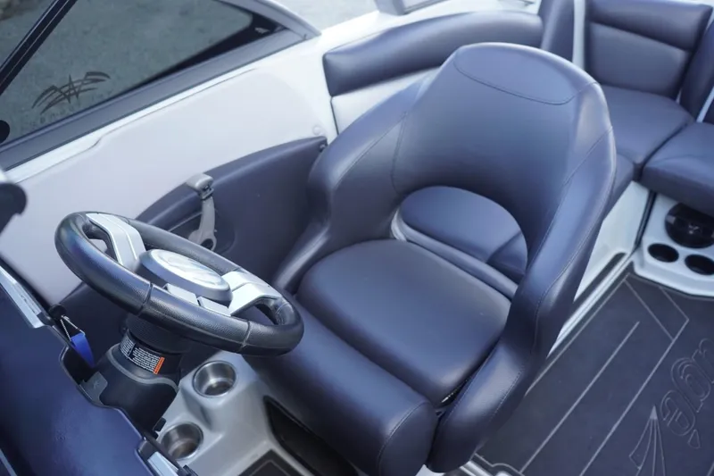 Slide: The Image of 2019 Tigé R20 boat interior with steering wheel and seating. - 25