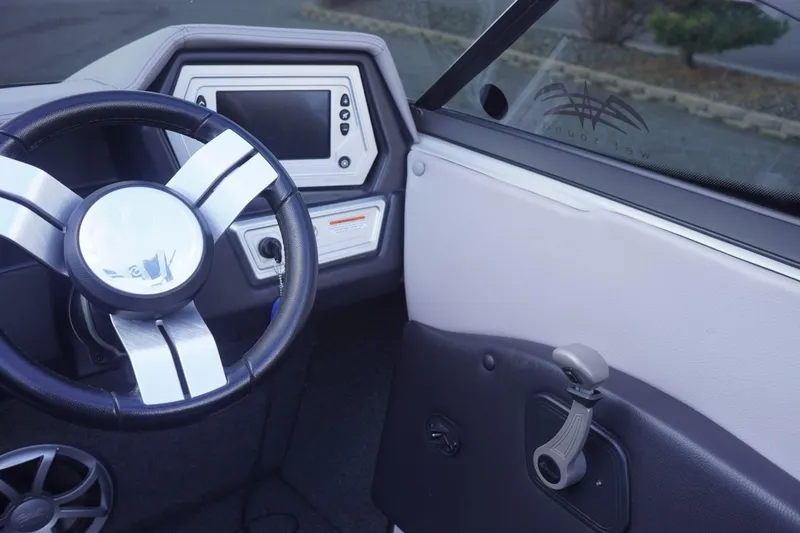 Slide: The Image of 2019 Tigé R20 boat interior with steering wheel and dashboard display. - 26