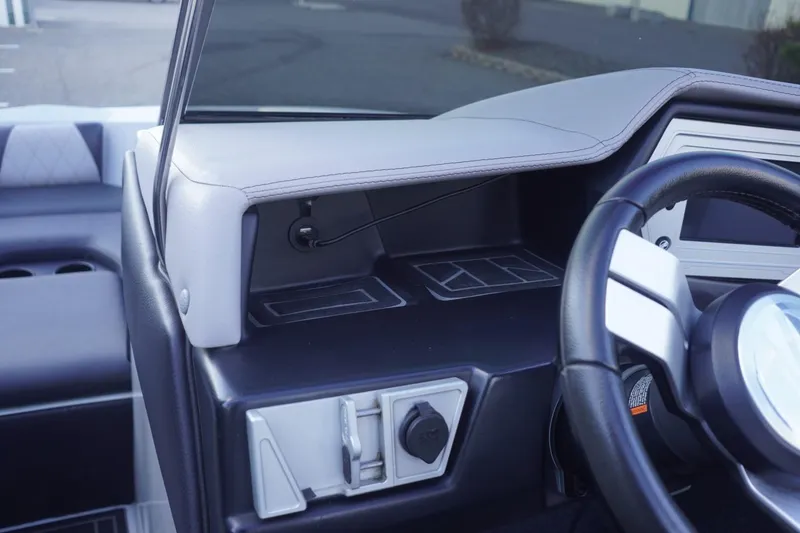 Slide: The Image of 2019 Tigé R20 boat dashboard with steering wheel and control panel. - 27