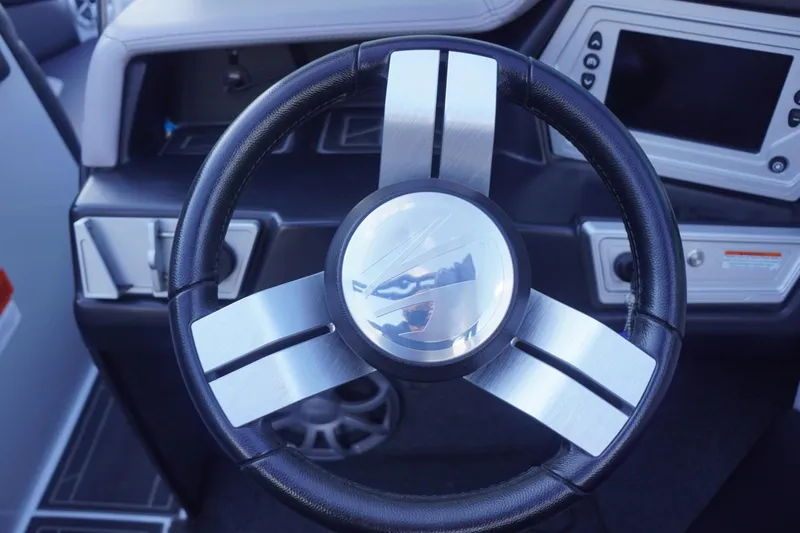 Slide: The Image of Steering wheel of 2019 Tigé R20 boat with modern dashboard controls. - 29