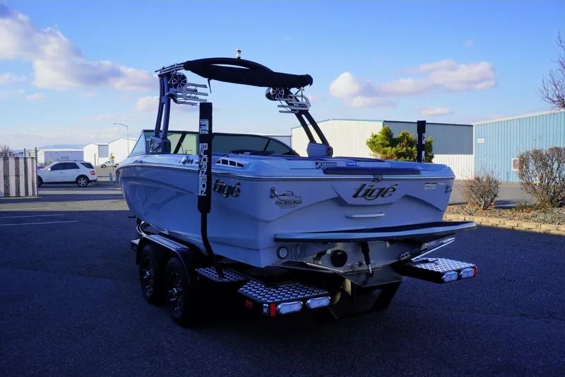 Slide: The Image of 2019 Tigé R20 boat on trailer in parking lot under blue sky. - 3