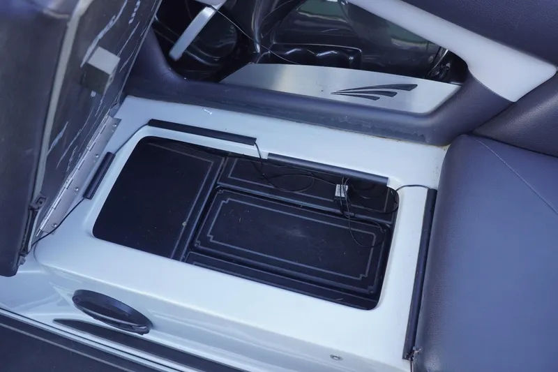 Slide: The Image of 2019 Tigé R20 boat interior storage compartment with open lid and visible wiring. - 34