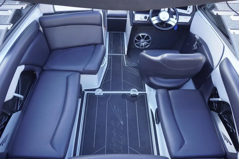 Slide: The Image of 2019 Tigé R20 boat interior with sleek black seating and modern dashboard design. - 35