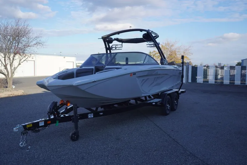 Slide: The Image of 2019 Tigé R20 boat on trailer in parking lot under blue sky. - 4