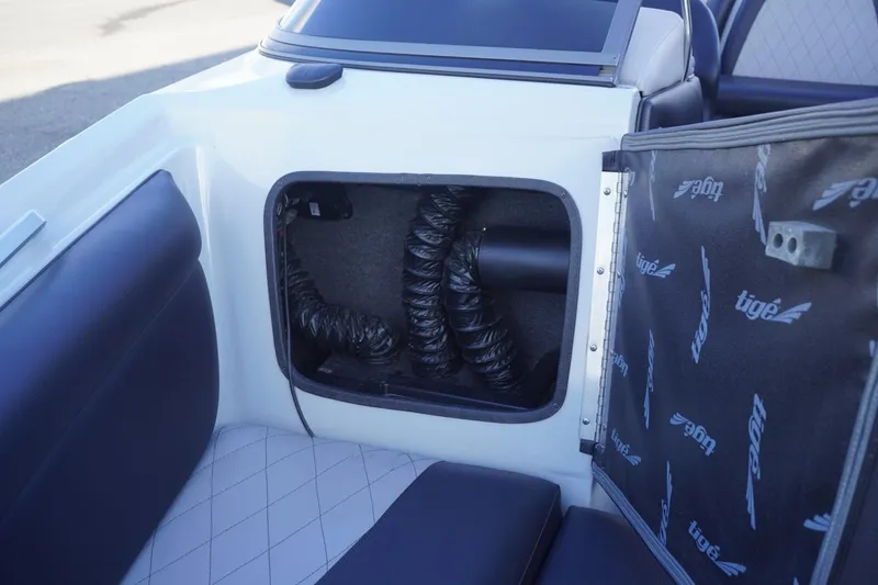Slide: The Image of 2019 Tigé R20 boat interior storage compartment with visible ventilation hoses. - 40