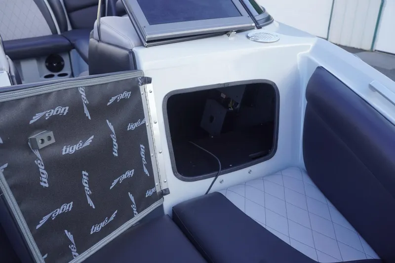 Slide: The Image of 2019 Tigé R20 boat interior with open storage compartment and branded panel. - 41