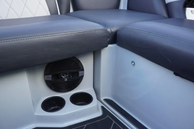 Slide: The Image of 2019 Tigé R20 boat interior with black seating, speaker, and cup holders. - 42