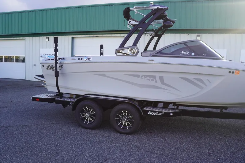 Slide: The Image of 2019 Tigé R20 boat on trailer, parked outside a green building. - 44