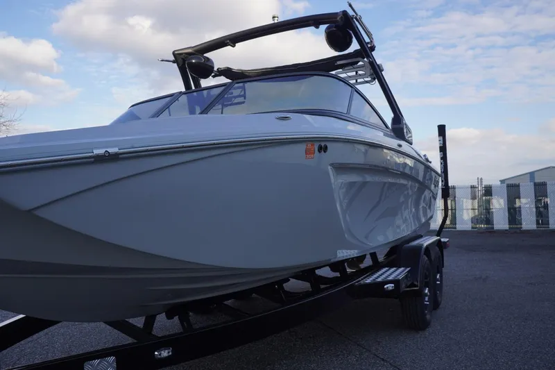 Slide: The Image of 2019 Tigé R20 boat on trailer, sleek design under a partly cloudy sky. - 5