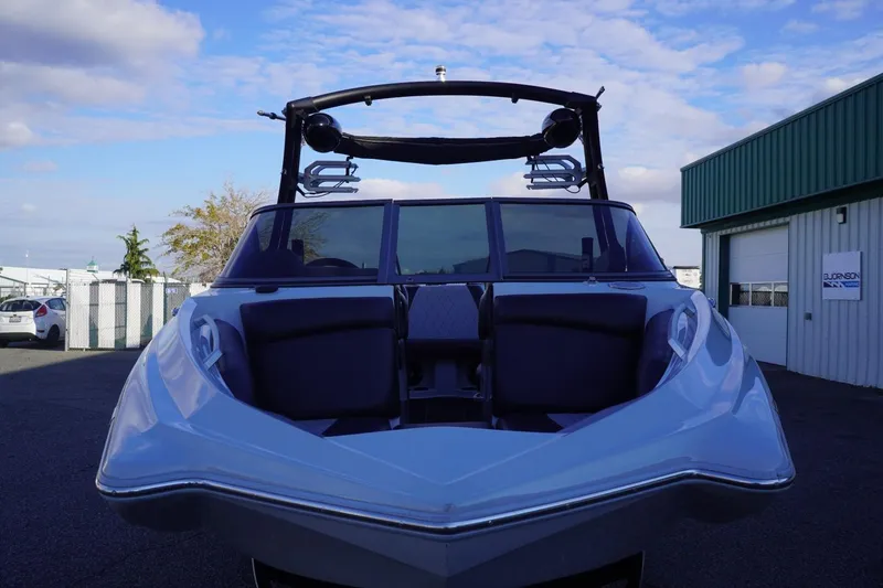 Slide: The Image of 2019 Tigé R20 boat with sleek design, parked outdoors under a blue sky. - 6