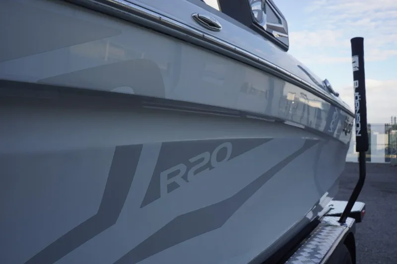 Slide: The Image of 2019 Tigé R20 boat side view with sleek design and branding. - 8