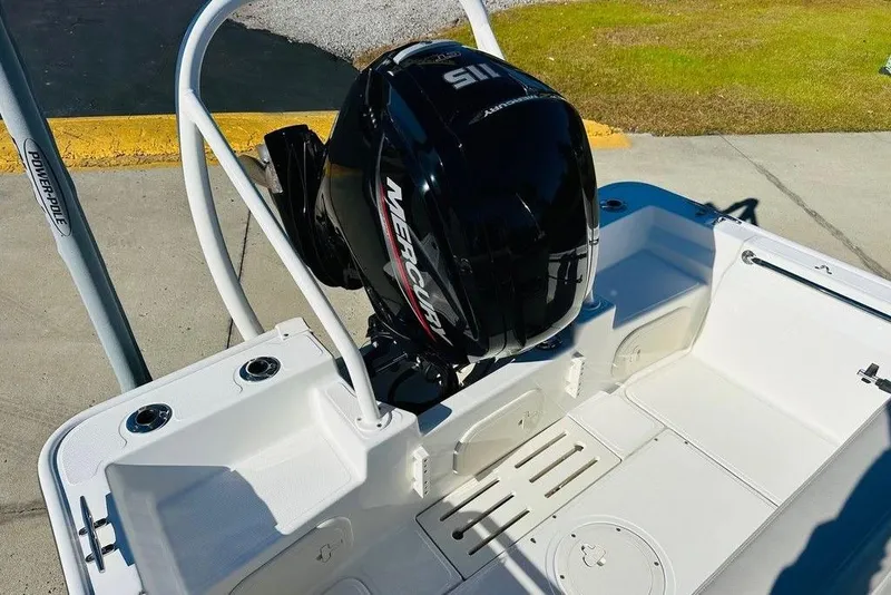 Slide: The Image of 2023 Boston Whaler 170 Montauk boat with Mercury engine, docked on concrete surface. - 5