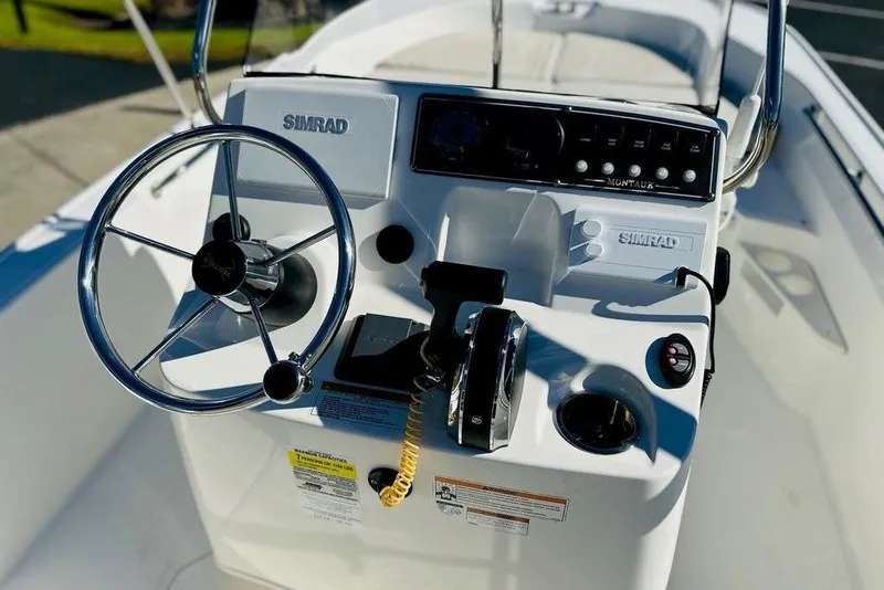 Slide: The Image of 2023 Boston Whaler 170 Montauk boat console with steering wheel and controls. - 7