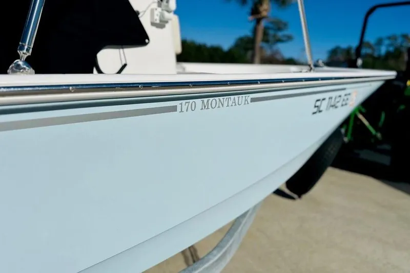 Slide: The Image of 2023 Boston Whaler 170 Montauk boat side view with registration number visible. - 9