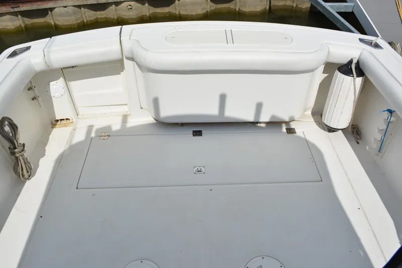 Slide: The Image of 2001 Shamrock 290 Walkaround boat deck with storage compartments and seating. - 10