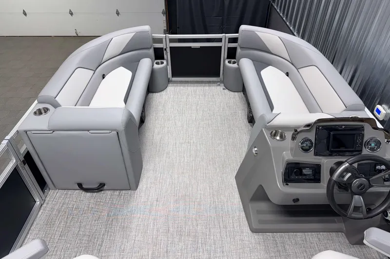 Slide: The Image of 2026 Avalon Venture 2385 QL Tritoon interior with gray seating and modern helm controls. - 12