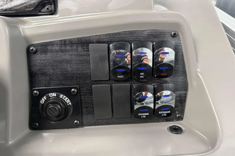 Slide: The Image of Control panel of 2026 Avalon Venture 2385 QL Tritoon with switches and start button. - 22