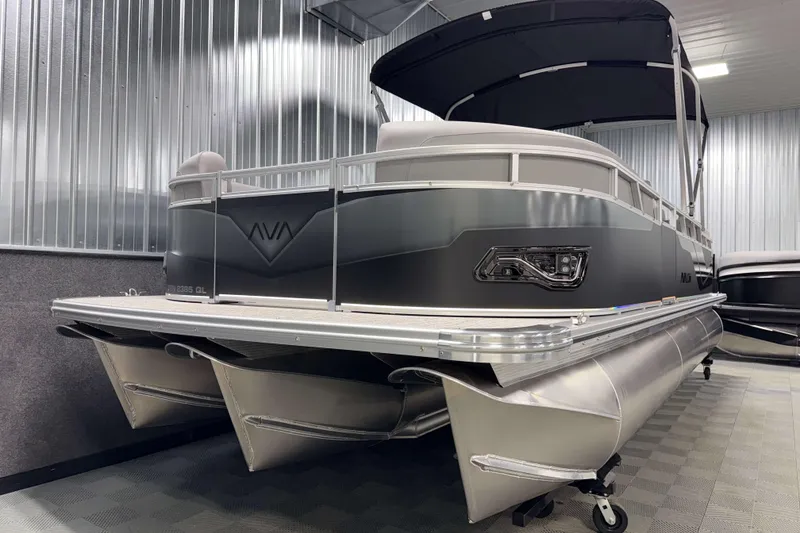 Slide: The Image of 2026 Avalon Venture 2385 QL Tritoon in showroom, sleek design, metallic finish. - 3
