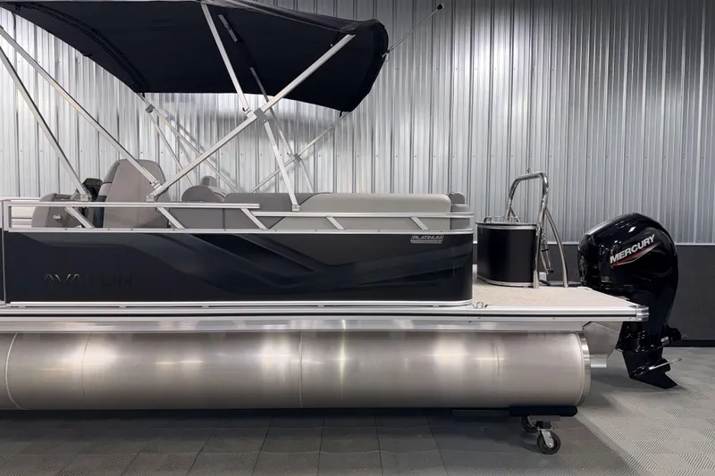 Slide: The Image of 2026 Avalon Venture 2385 QL Tritoon with Mercury outboard in a showroom setting. - 6