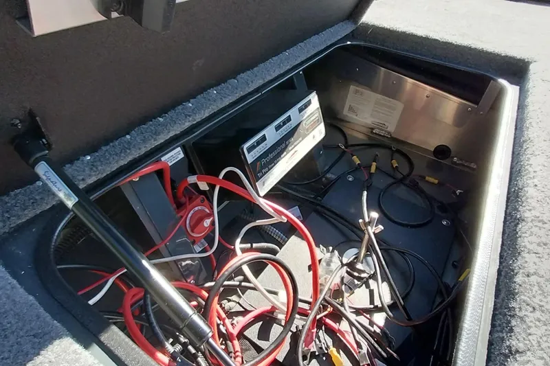 Slide: The Image of Open compartment of 2025 Ranger ALPHA 208 showing wiring and battery setup. - 12