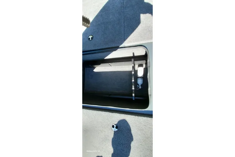 Slide: The Image of Open storage compartment in 2025 Ranger ALPHA 208 boat, showing interior details. - 15