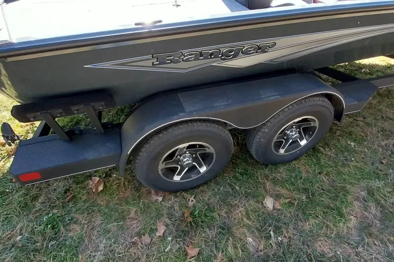 Slide: The Image of Trailer of 2025 Ranger ALPHA 208 boat with dual wheels on grass. - 20