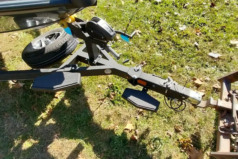 Slide: The Image of Trailer hitch of Ranger ALPHA 208, 2025 model, on grassy ground. - 23