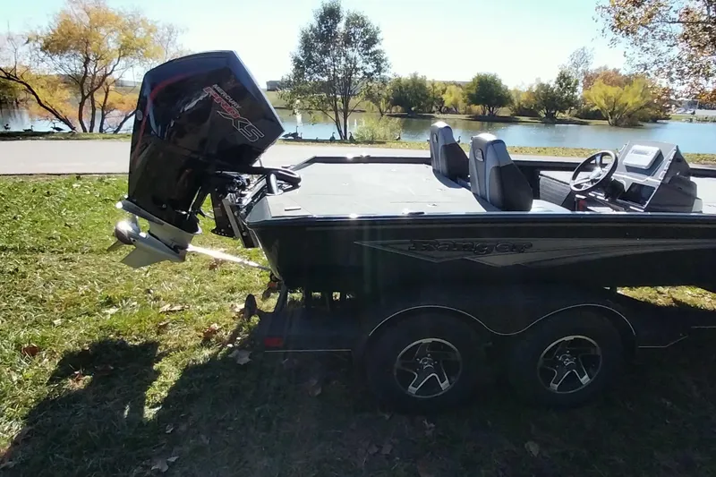 Slide: The Image of 2025 Ranger ALPHA 208 boat on trailer by a scenic lake. - 30