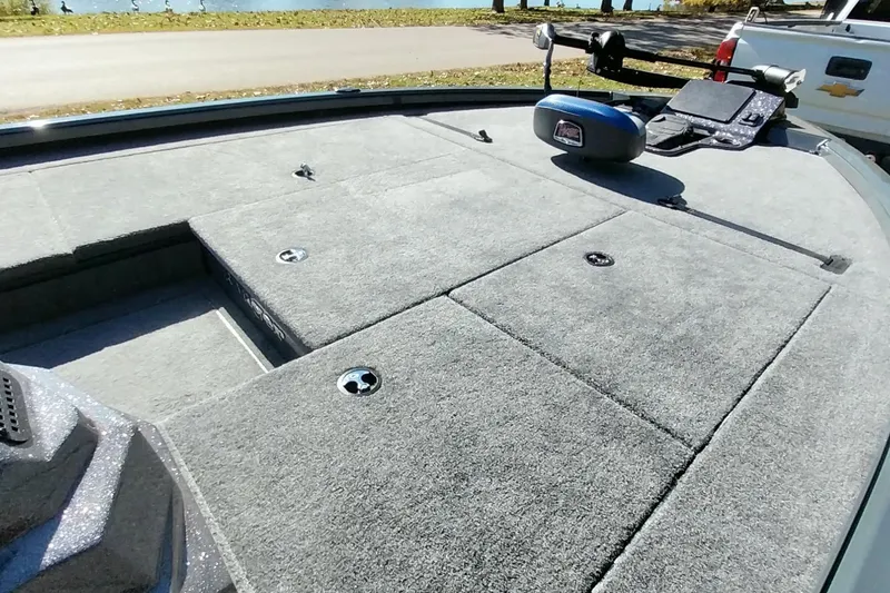 Slide: The Image of 2025 Ranger ALPHA 208 boat deck with carpeted surface and storage compartments. - 5