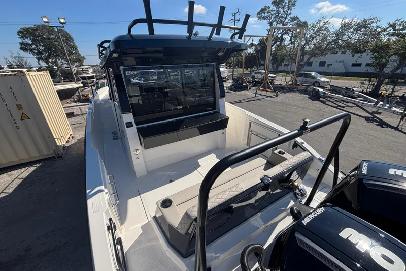 Slide: The Image of 2026 Navan C30 boat with Mercury engines, docked outdoors under a clear blue sky. - 10