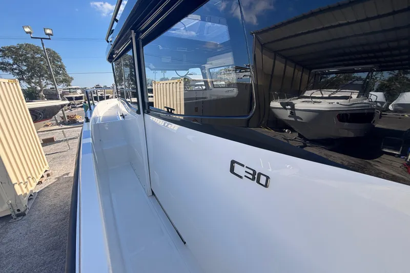 Slide: The Image of 2026 Navan C30 boat side view in a marina with clear blue sky. - 12