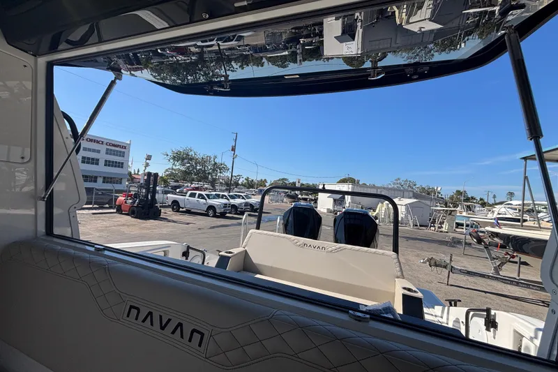 Slide: The Image of Interior view of 2026 Navan C30 boat at a marina with parked vehicles. - 26
