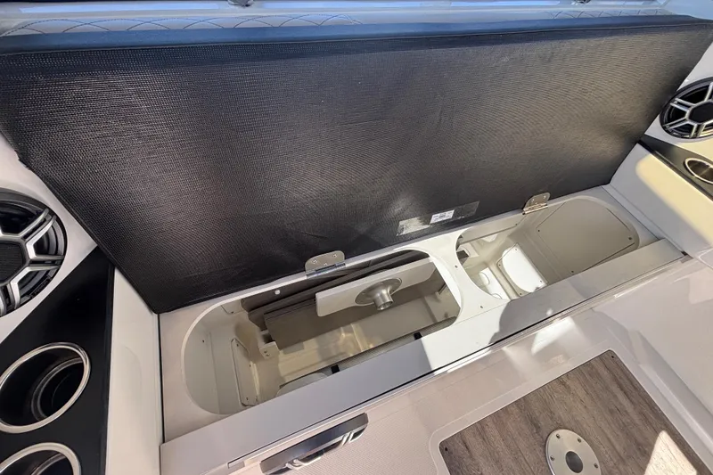 Slide: The Image of 2026 Navan C30 boat interior storage compartment with cup holders and speakers. - 29