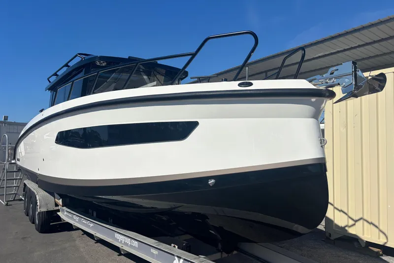 Slide: The Image of 2026 Navan C30 boat on trailer under clear blue sky. - 4