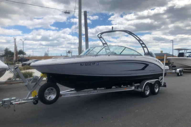 Slide: The Image of 2021 Chaparral 23 SSi boat on trailer under cloudy sky. - 2
