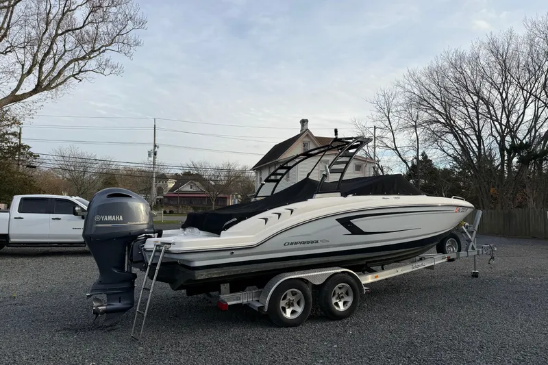 Slide: The Image of 2021 Chaparral 23 SSi boat on trailer with Yamaha outboard motor in residential area. - 5