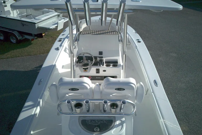 Slide: The Image of 2026 BlackJack 256 Coastal boat interior with steering console and seating. - 10