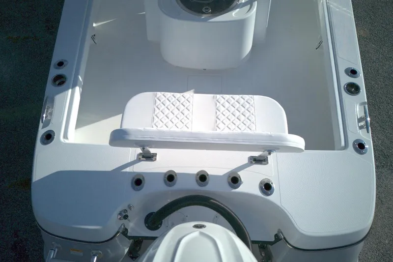 Slide: The Image of 2026 BlackJack 256 Coastal boat interior with white seating and rod holders. - 12