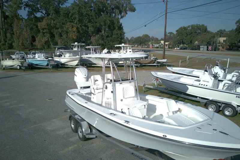 Slide: The Image of 2026 BlackJack 256 Coastal boat on trailer in dealership lot, surrounded by other boats. - 3