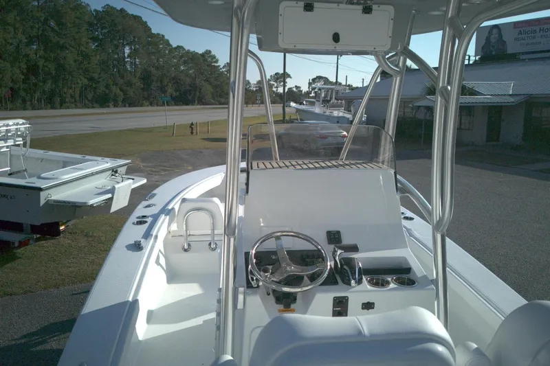 Slide: The Image of 2026 BlackJack 256 Coastal boat interior with steering console and seating. - 5