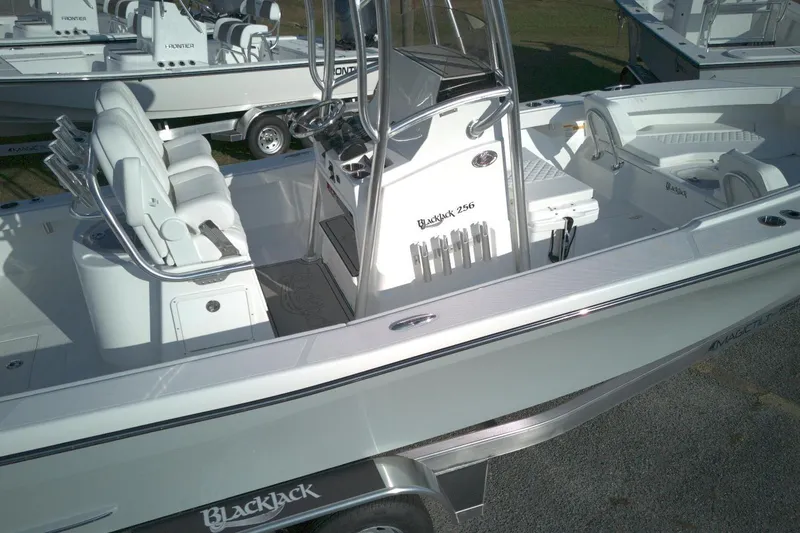 Slide: The Image of 2026 BlackJack 256 Coastal boat with sleek design and modern features, docked on trailer. - 9